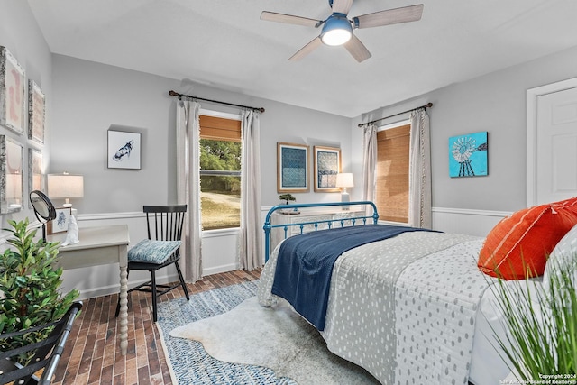 bedroom with a ceiling fan and baseboards