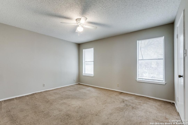 unfurnished room with light carpet, ceiling fan, and a textured ceiling