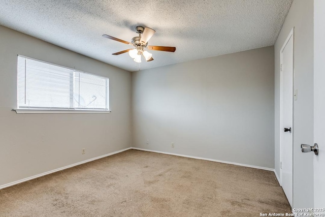 carpeted spare room featuring a textured ceiling and ceiling fan