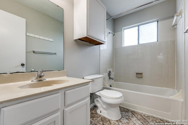 full bathroom featuring toilet, tile patterned flooring, tiled shower / bath, and vanity