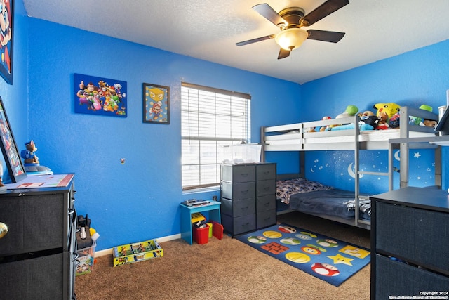 bedroom with a textured ceiling, ceiling fan, and carpet