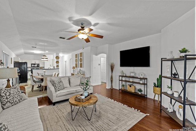 living room with ceiling fan, lofted ceiling, and hardwood / wood-style floors