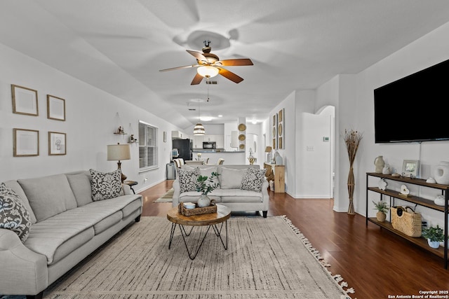 living room featuring ceiling fan and hardwood / wood-style flooring