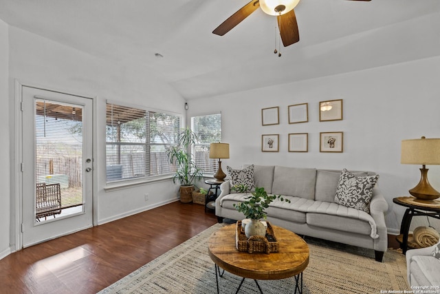 living room with ceiling fan, dark hardwood / wood-style flooring, and lofted ceiling