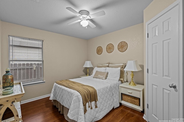 bedroom with ceiling fan and dark hardwood / wood-style floors