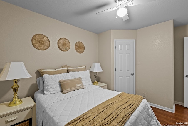 bedroom with dark wood-type flooring and ceiling fan