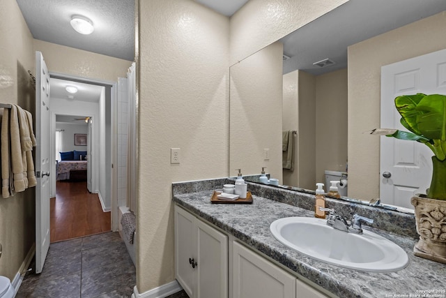 bathroom with tile patterned floors, vanity, toilet, a shower with shower curtain, and ceiling fan