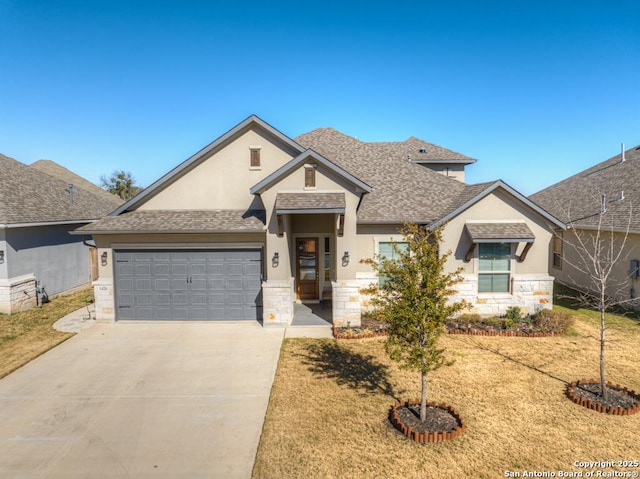 view of front of house with a front yard and a garage