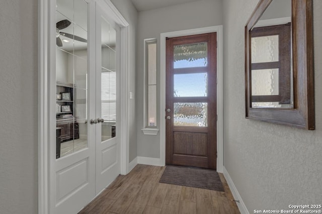 entryway with hardwood / wood-style floors