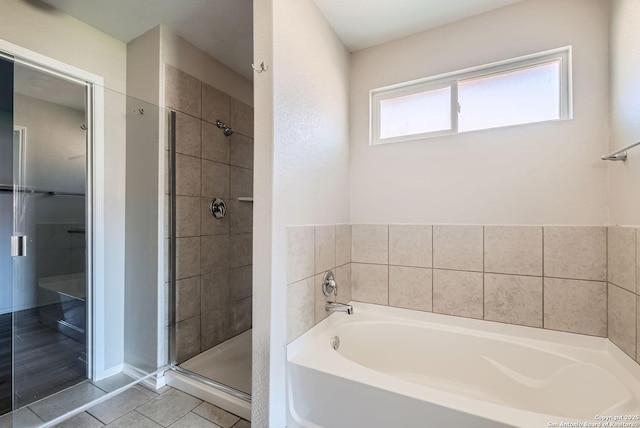 bathroom featuring independent shower and bath and tile patterned flooring