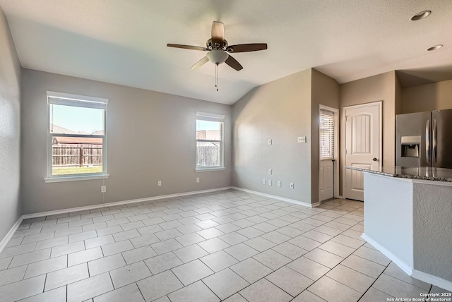 unfurnished room with ceiling fan and light tile patterned flooring