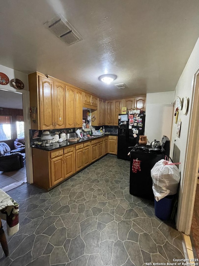 kitchen with black fridge