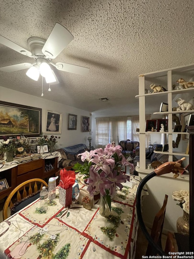 dining room featuring a textured ceiling and ceiling fan