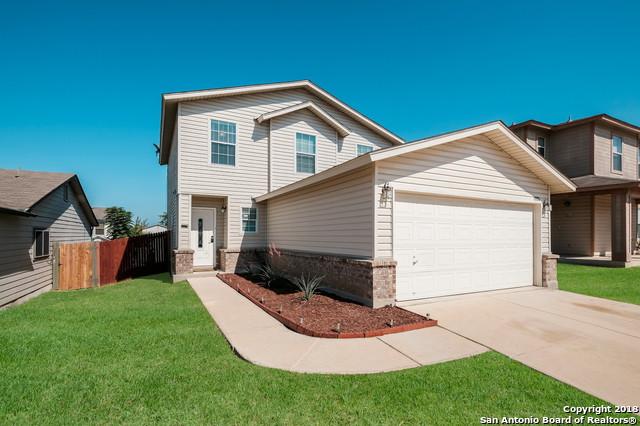 view of property featuring a front lawn and a garage