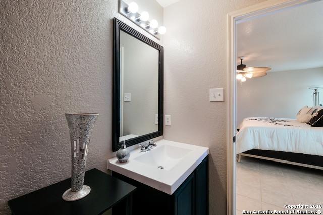 bathroom featuring ceiling fan and vanity