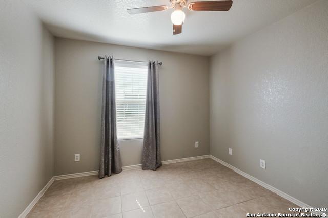 unfurnished room featuring ceiling fan and light tile patterned flooring