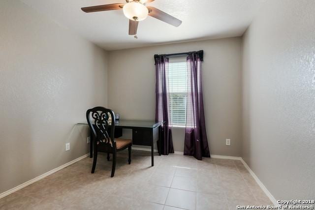 tiled office space featuring ceiling fan