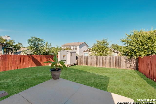 view of yard featuring a storage unit and a patio