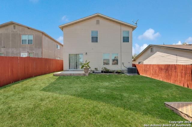 back of house featuring a patio area and a yard