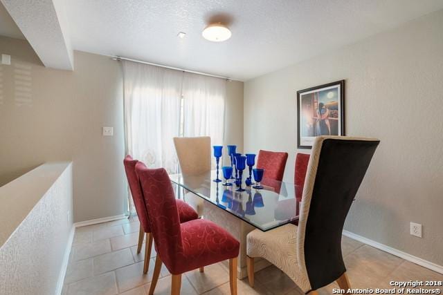 dining area featuring a textured ceiling