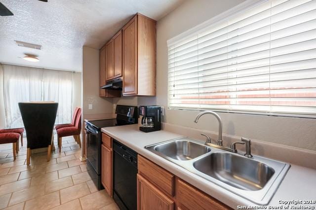 kitchen featuring light tile patterned floors, black dishwasher, electric range oven, a textured ceiling, and sink