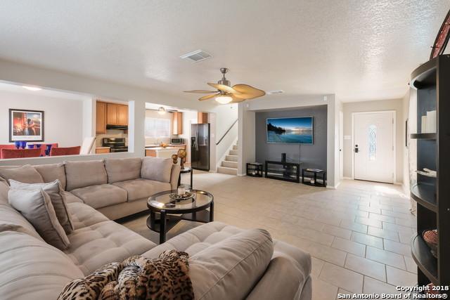 living room featuring a textured ceiling and ceiling fan