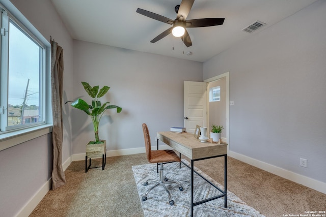 office space featuring ceiling fan and light colored carpet