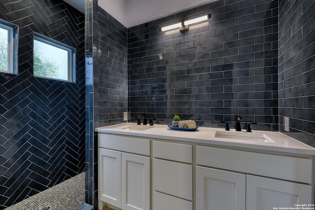 bathroom with decorative backsplash, tile walls, tiled shower, and vanity