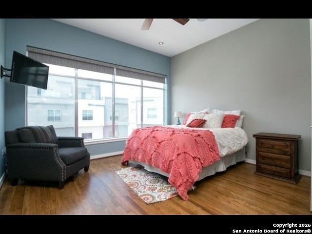 bedroom with ceiling fan and wood-type flooring