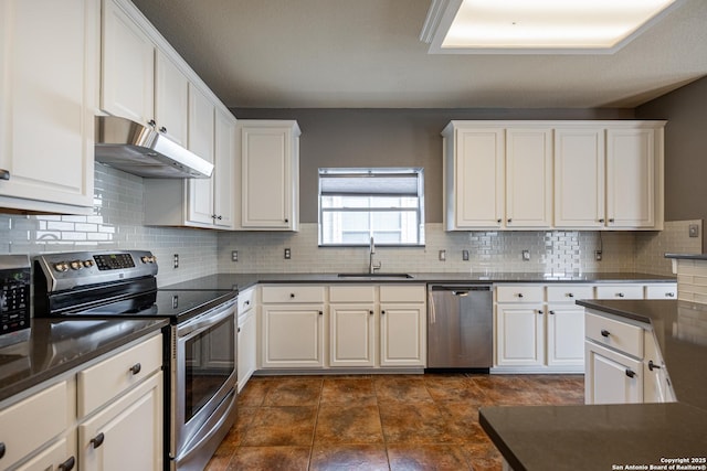 kitchen with white cabinetry, appliances with stainless steel finishes, sink, and backsplash