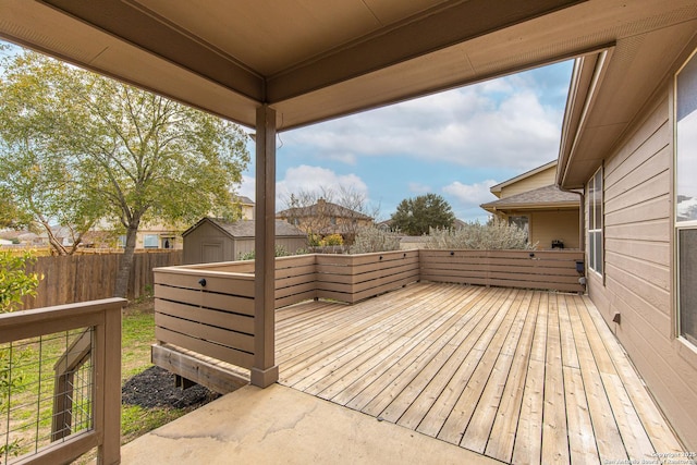 wooden deck featuring a storage unit