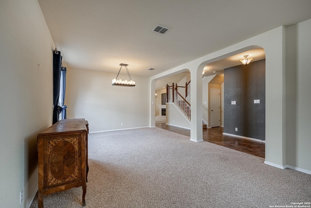 living room featuring carpet flooring and a notable chandelier