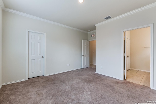 unfurnished bedroom with connected bathroom, crown molding, and light colored carpet