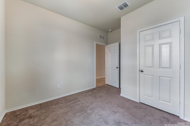 unfurnished bedroom with light colored carpet