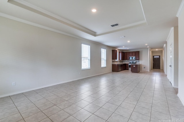 unfurnished living room featuring light tile patterned floors, ornamental molding, and a raised ceiling