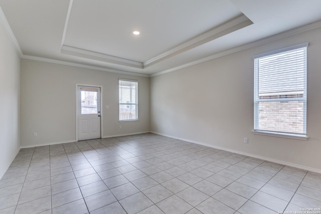 unfurnished room with light tile patterned floors, crown molding, and a raised ceiling