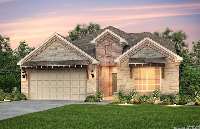 view of front facade with a garage and a yard