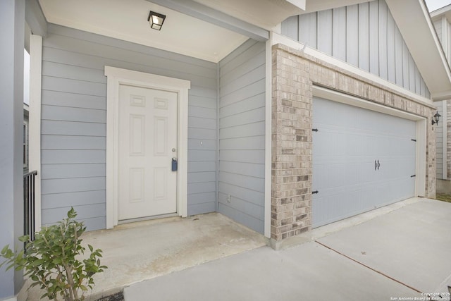 view of exterior entry featuring a garage