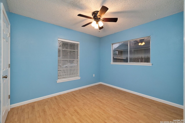 spare room featuring a textured ceiling, ceiling fan, and light hardwood / wood-style flooring