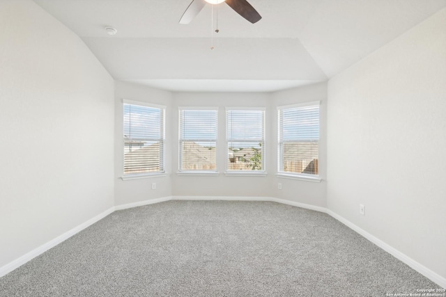 carpeted empty room with ceiling fan and lofted ceiling