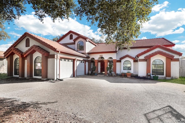 mediterranean / spanish-style house featuring a garage