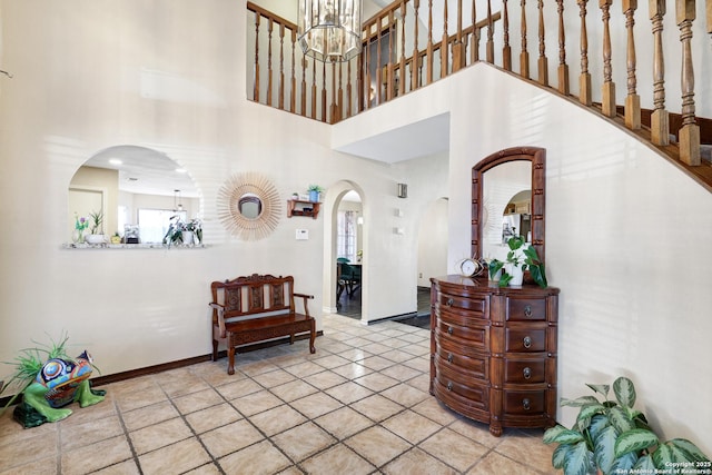 foyer featuring a high ceiling and a notable chandelier