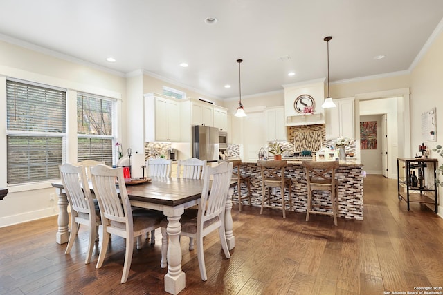 dining room featuring dark hardwood / wood-style flooring and ornamental molding