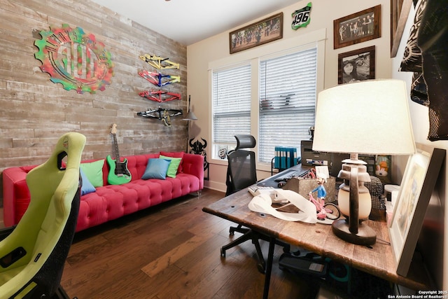 office space with dark wood-type flooring and wooden walls