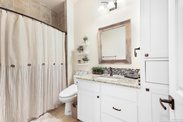 bathroom featuring toilet, backsplash, tile patterned flooring, a shower with curtain, and vanity