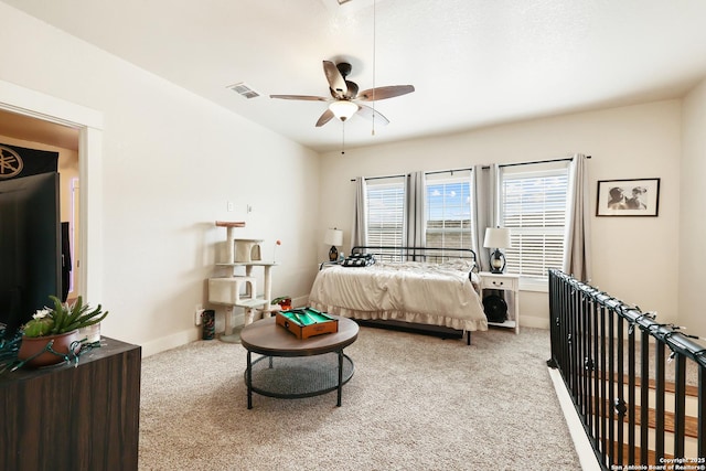 bedroom featuring ceiling fan and carpet