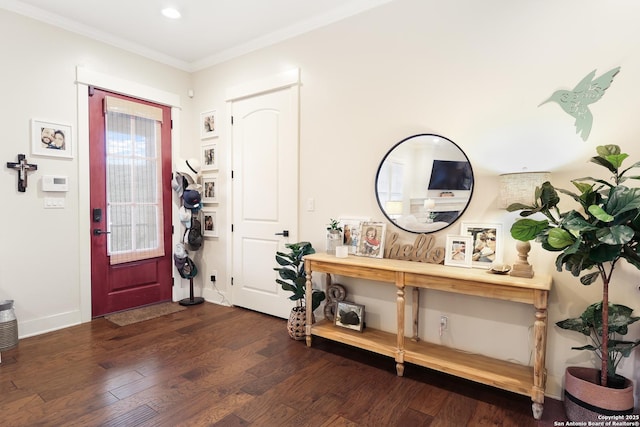 entryway with dark hardwood / wood-style flooring and ornamental molding