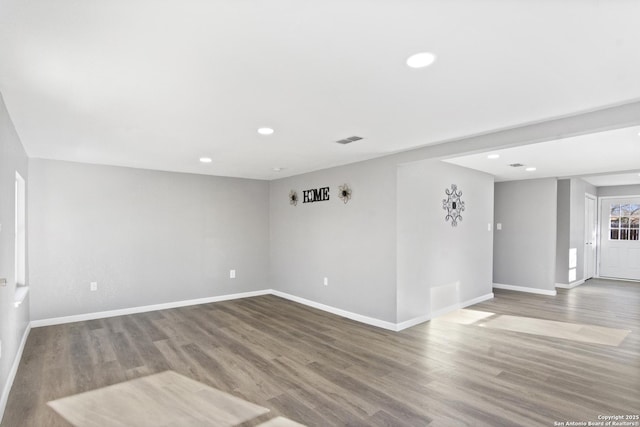 unfurnished room with wood-type flooring