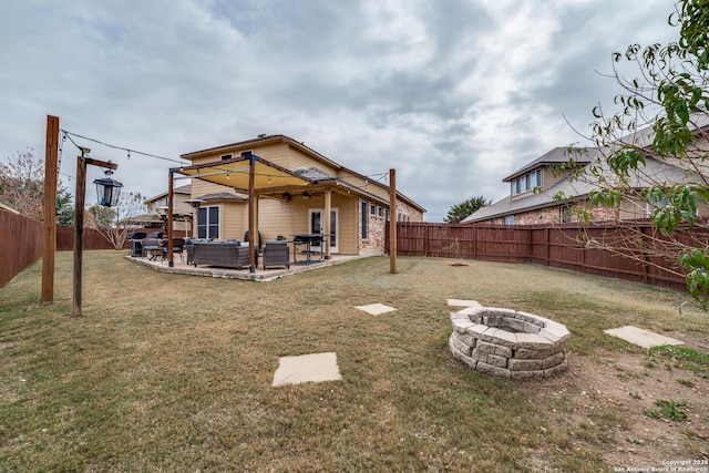 rear view of property with a patio area, an outdoor living space with a fire pit, and a yard