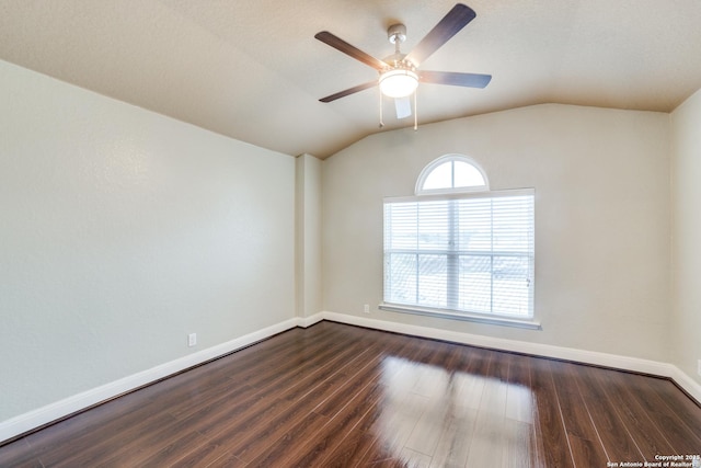 spare room with ceiling fan, vaulted ceiling, and dark hardwood / wood-style flooring